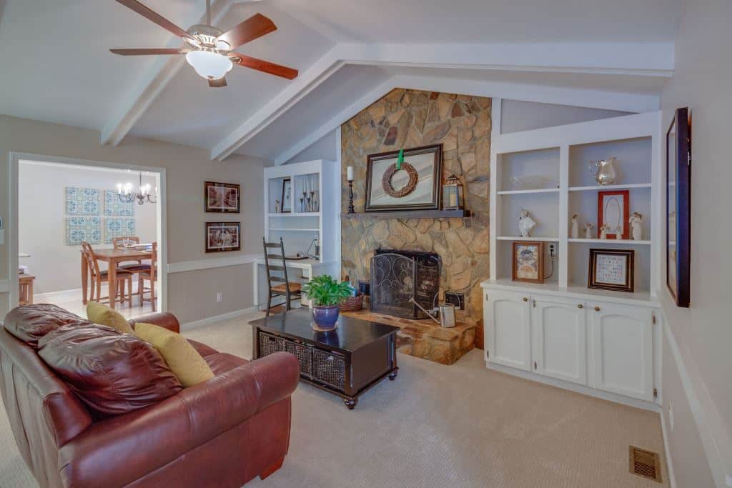 beamed great room with fireplace at this Charlotte Mid-Century Modern Home.