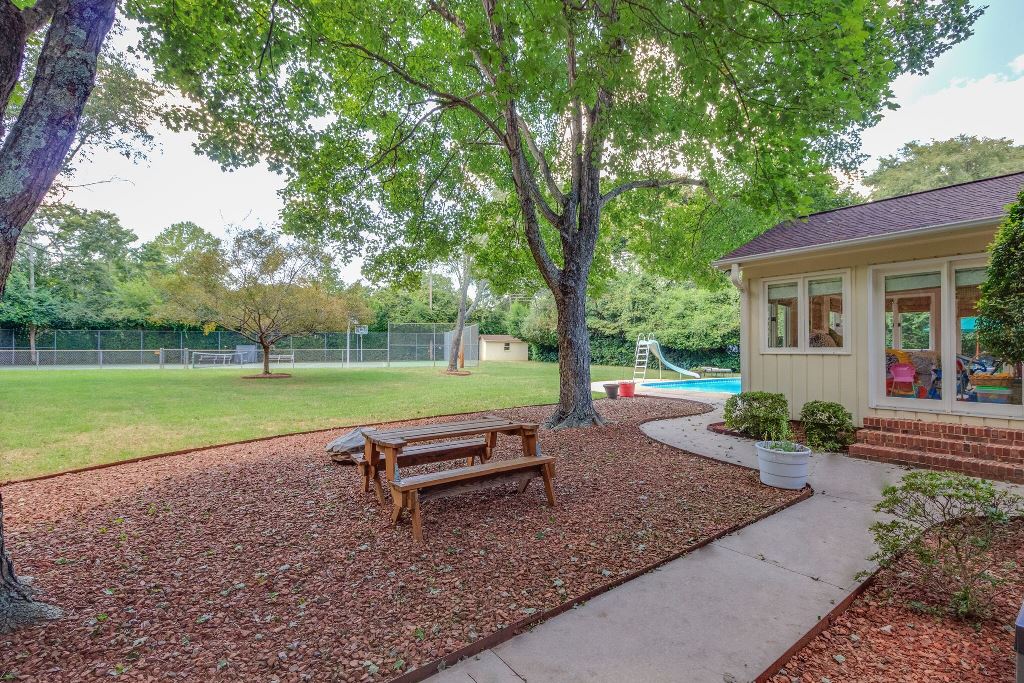 Park-like setting of this Charlotte Mid-Century Modern Home with tennis court