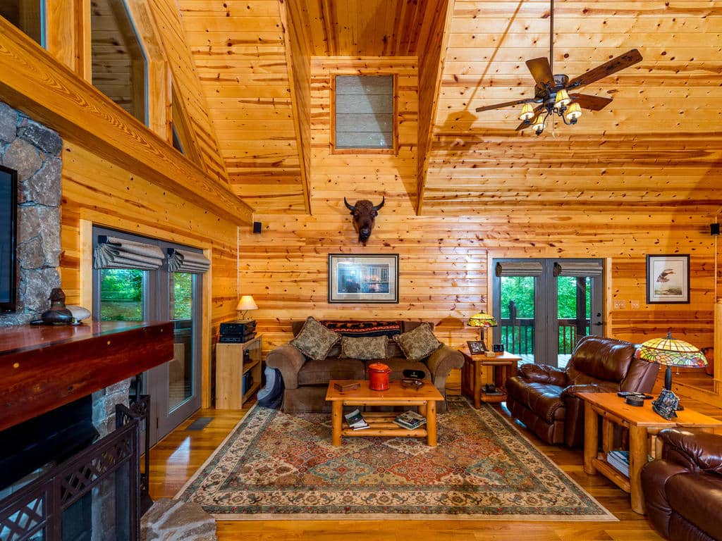 Image of Great Room with cathedral ceiling and French doors opening on the deck at 733 Bolens Creek Rd, Burnsville, an NC mountain cabin for sale.