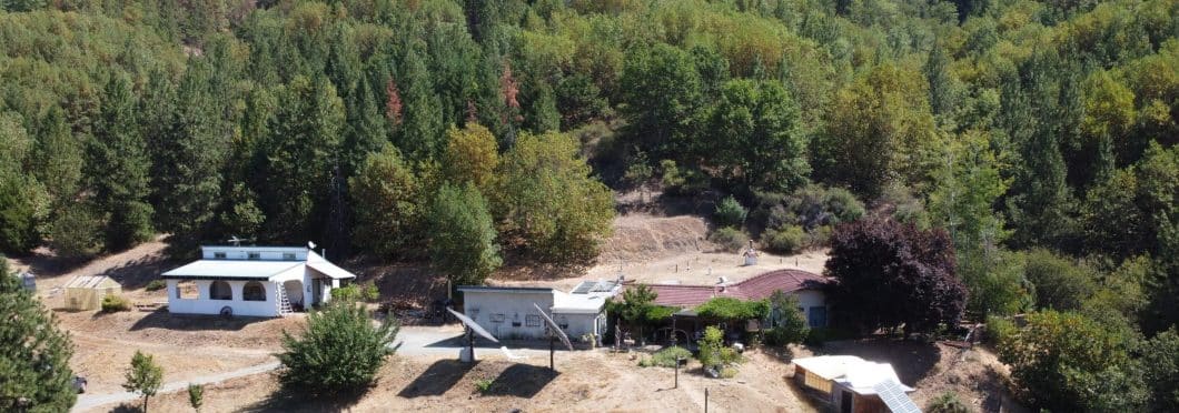 Aerial view of the earth-sheltered off grid home and acreage.