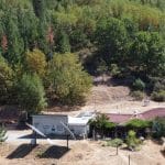 Aerial view of the earth-sheltered off grid home and acreage.